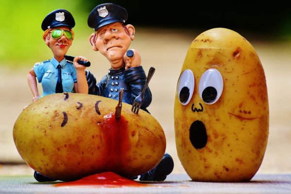 A murdered potato with a sad potato and two cops